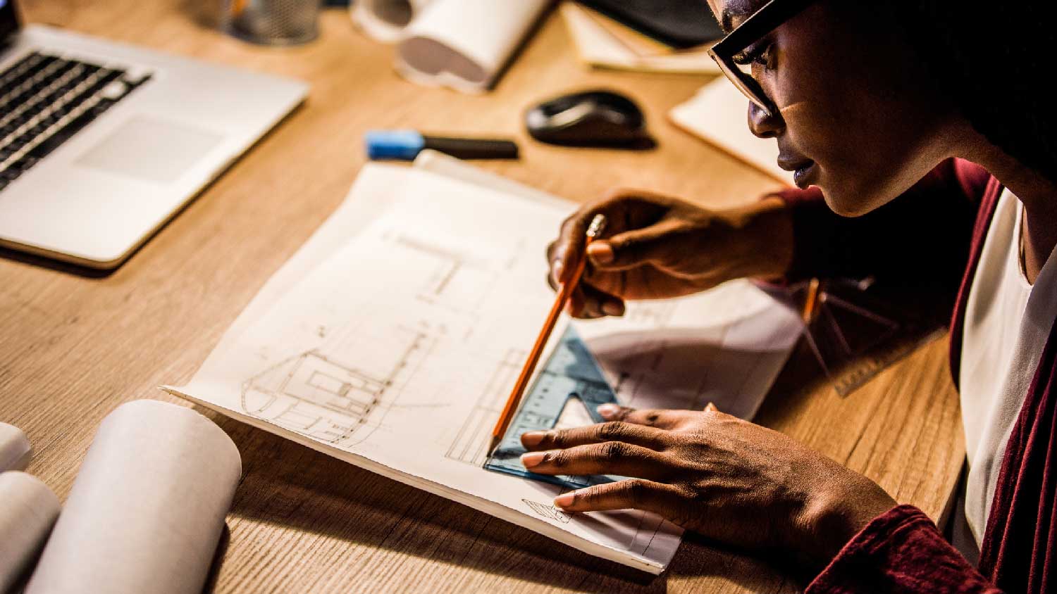 An architect drawing blueprints of a project