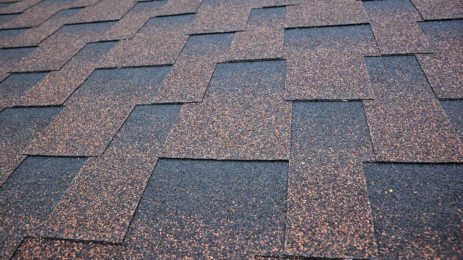 Closeup of asphalt roof shingles installed on a house