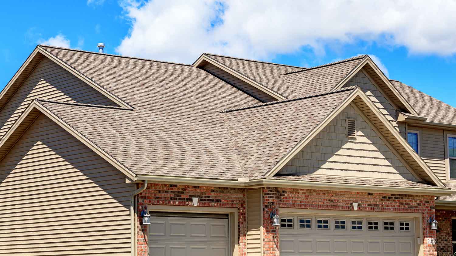 House with asphalt shingles roof in a sunny setting