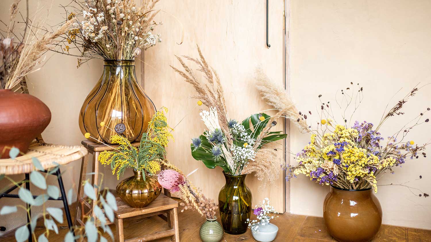 Assorted flower vases with dry flowers
