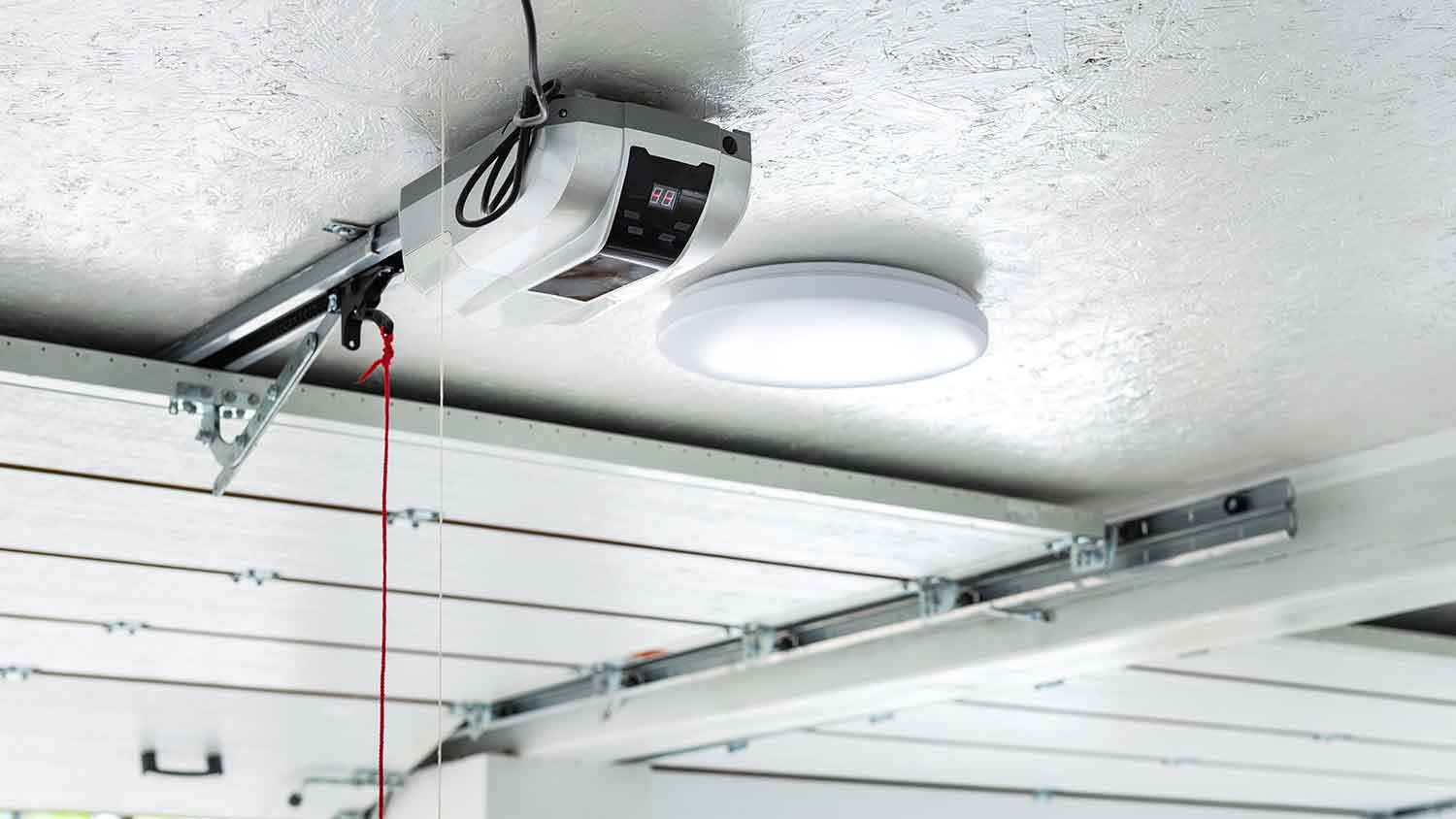 Garage door opener motor mounted on the ceiling