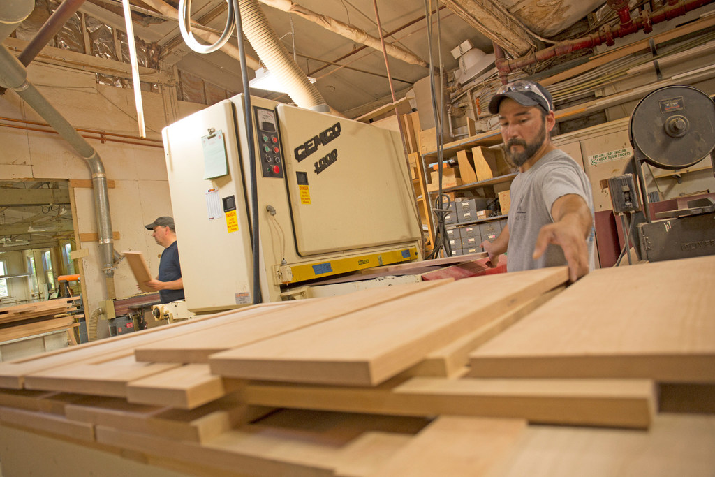 Taggart Construction employees work with lumber at their Maine shop