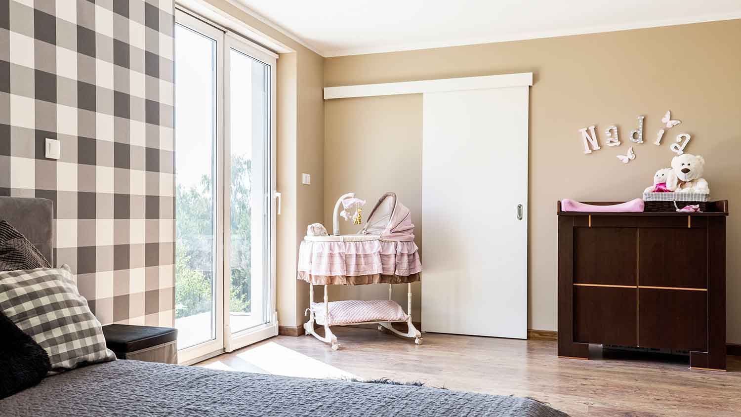 Baby bassinet in a sunny corner of the bedroom