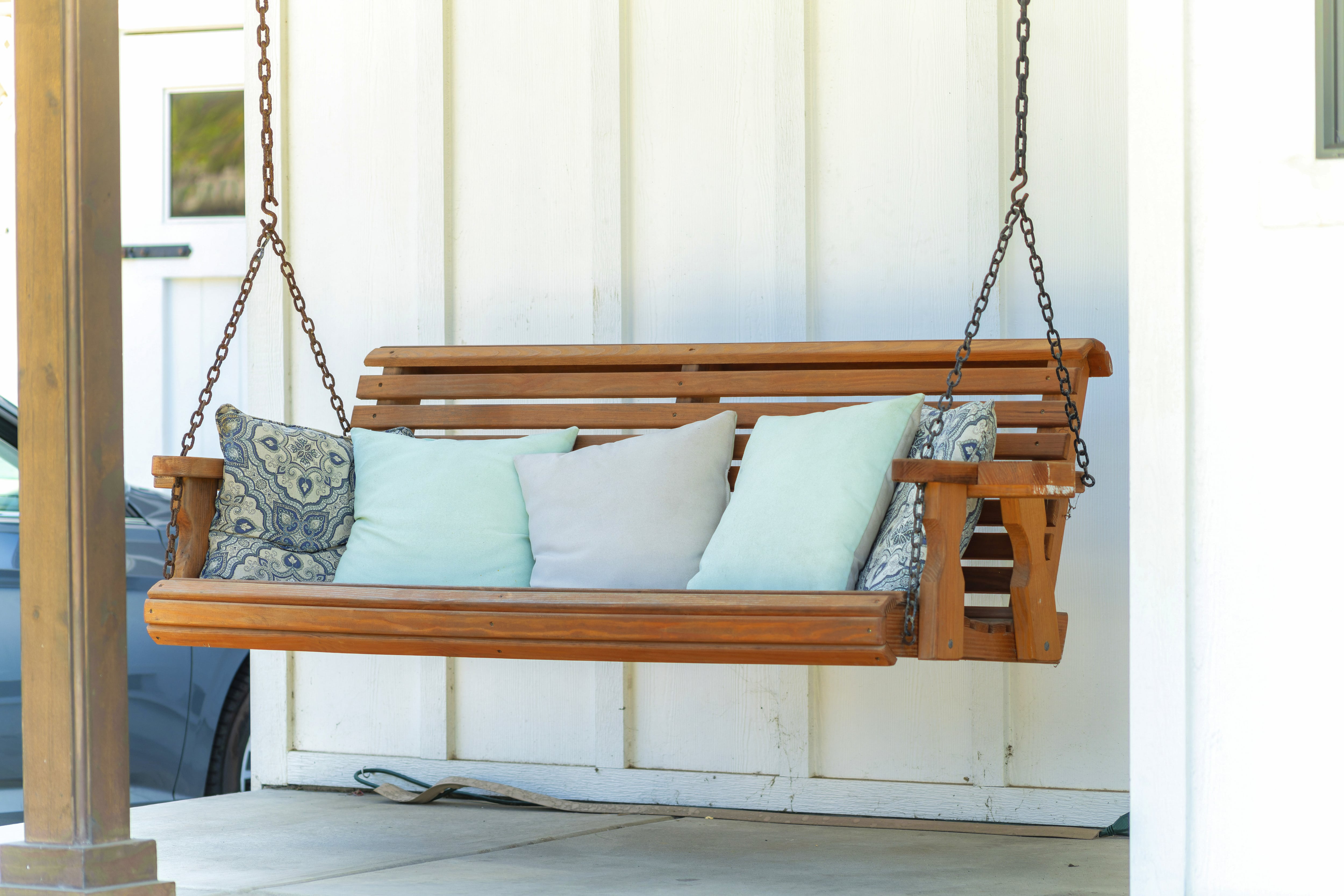 Bench porch swing with throw pillows