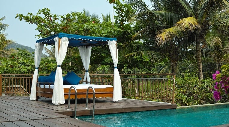 beautiful backyard cabana on pool deck