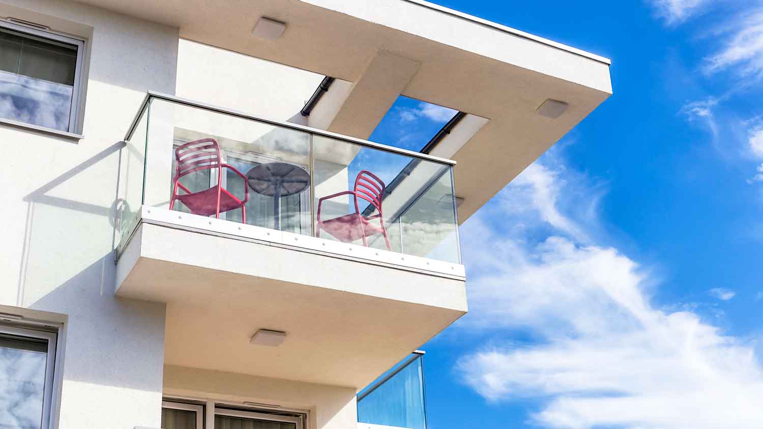 Balcony with a glass railing on a modern building