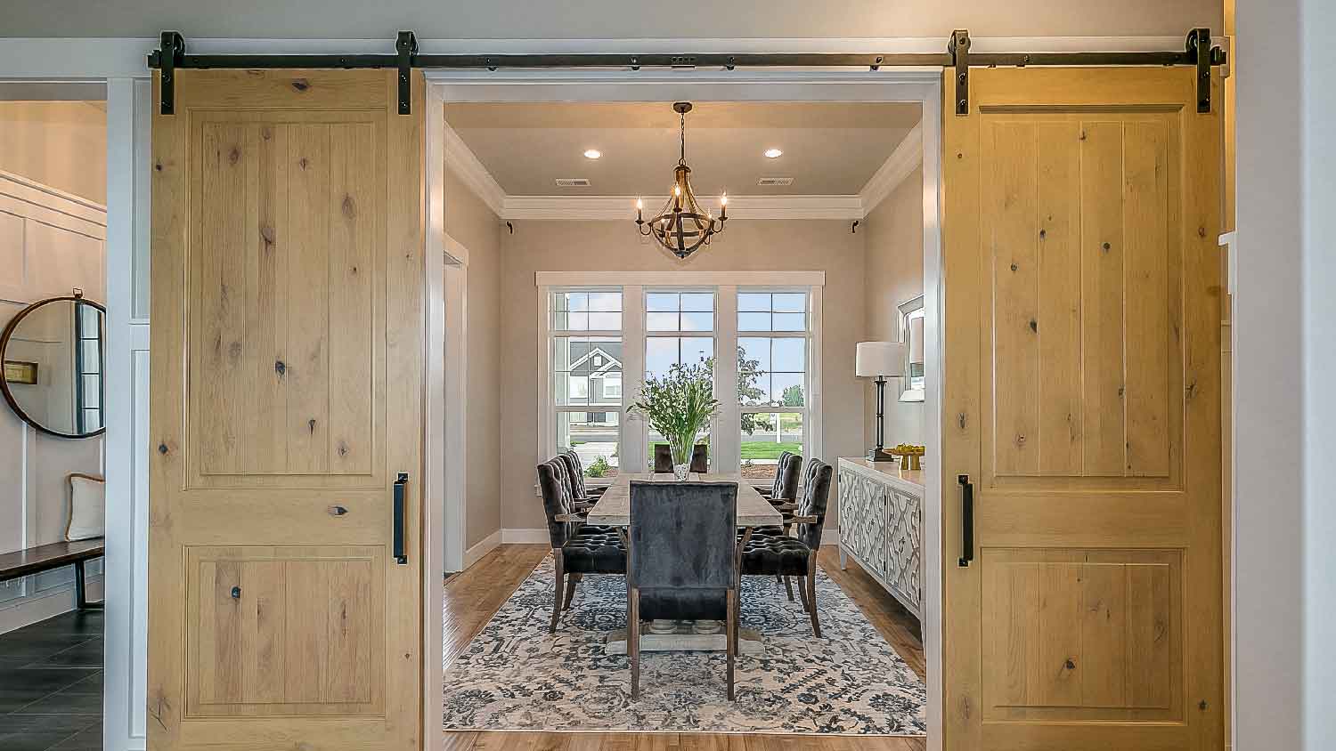 Barn doors leading to a dining room