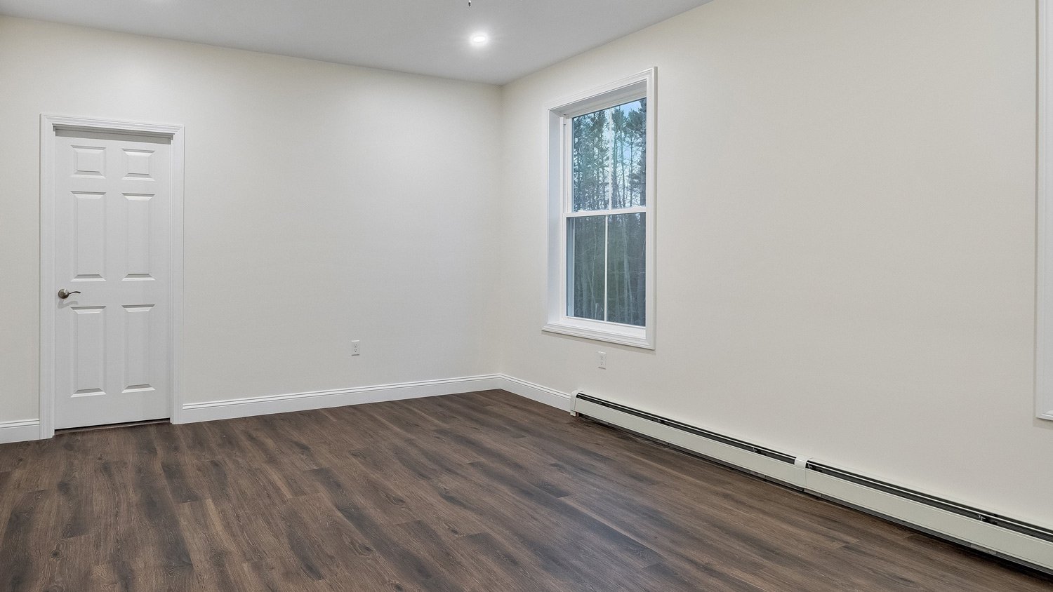 a baseboard heater on the white wall