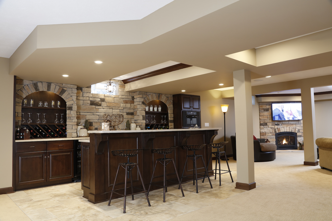 basement bar with stone detailing on wall