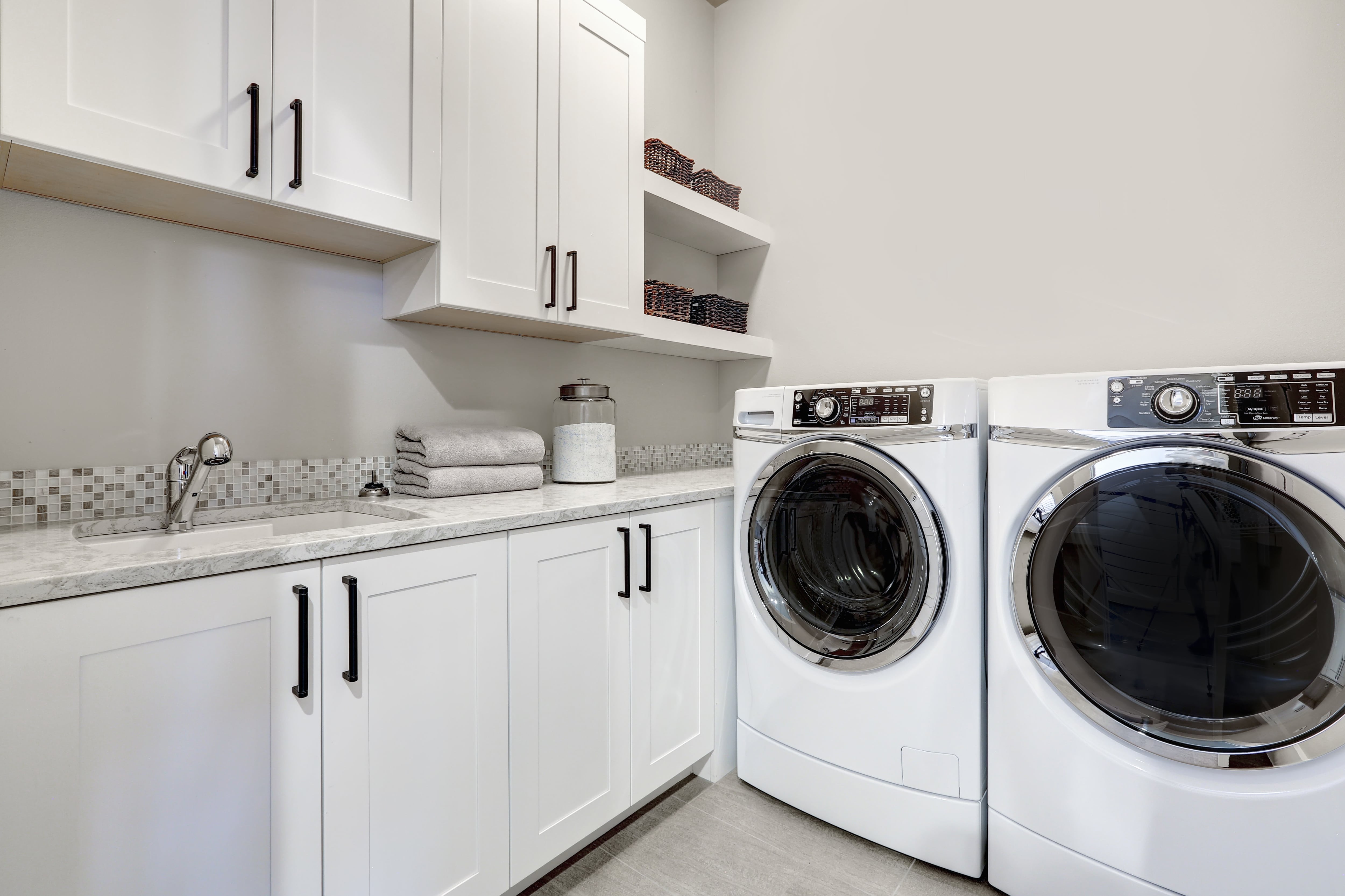 Modern laundry room with white cabinetry