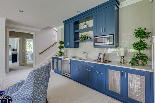 Kitchen with blue cabinets installed in the basement