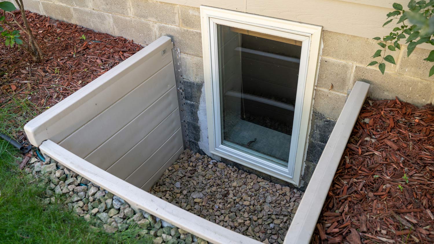 Exterior view of a basement bedroom window