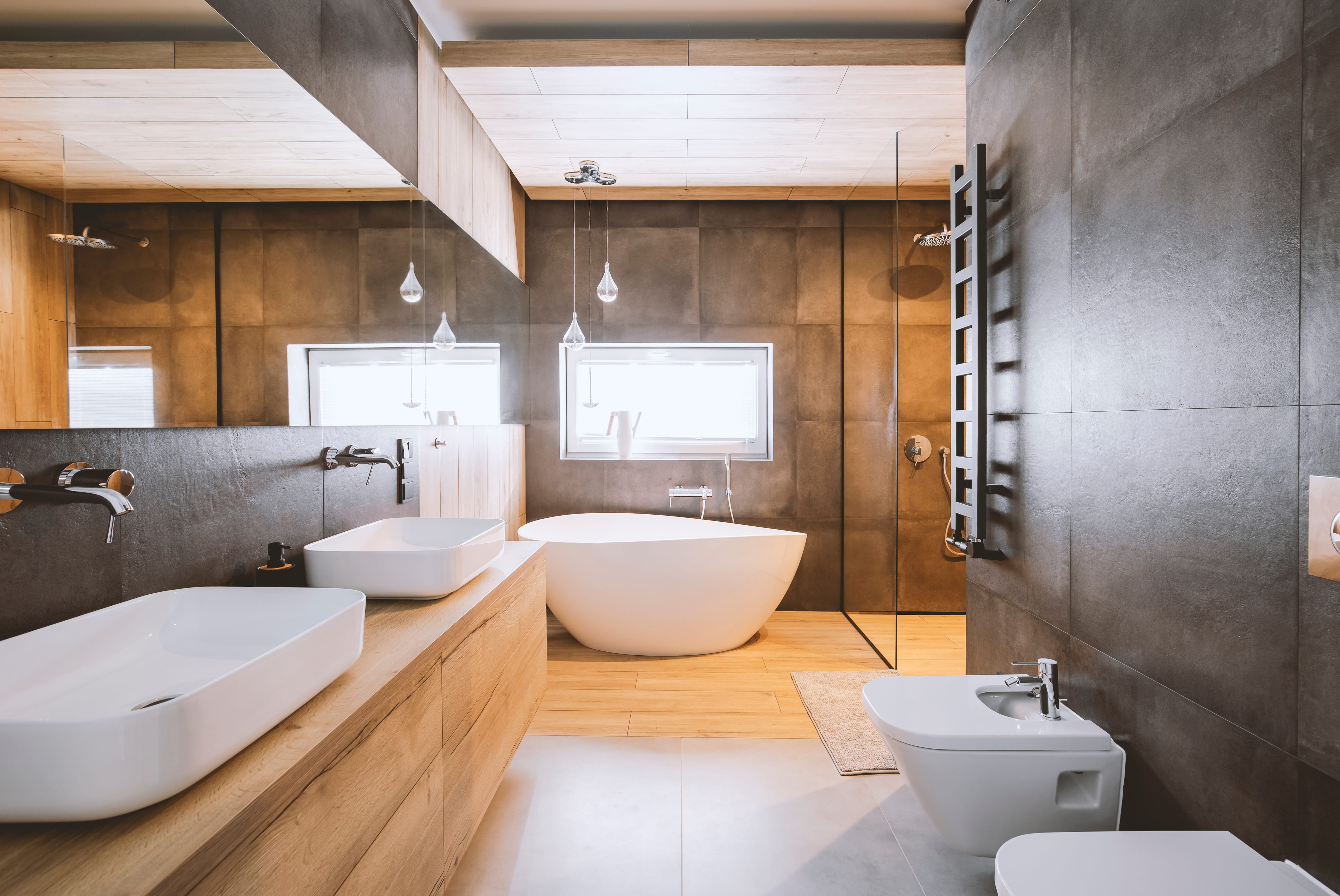 Modern bathroom with concrete backsplash, white vessel sink, and wooden accent wall