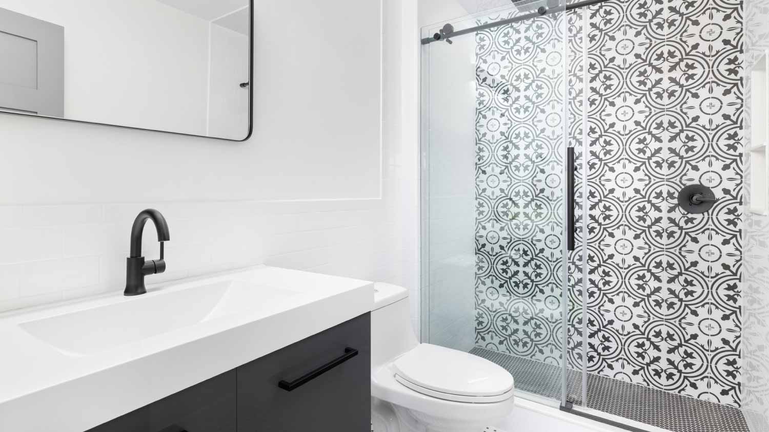 Bathroom with a grey cabinet and tiled shower