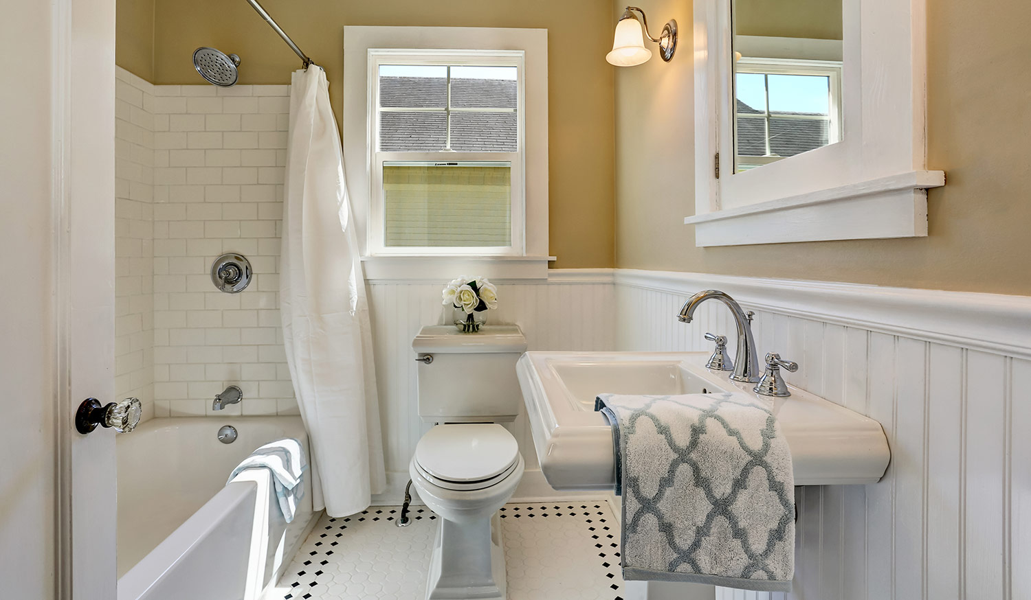 Bathroom interior in white tones and tile floor