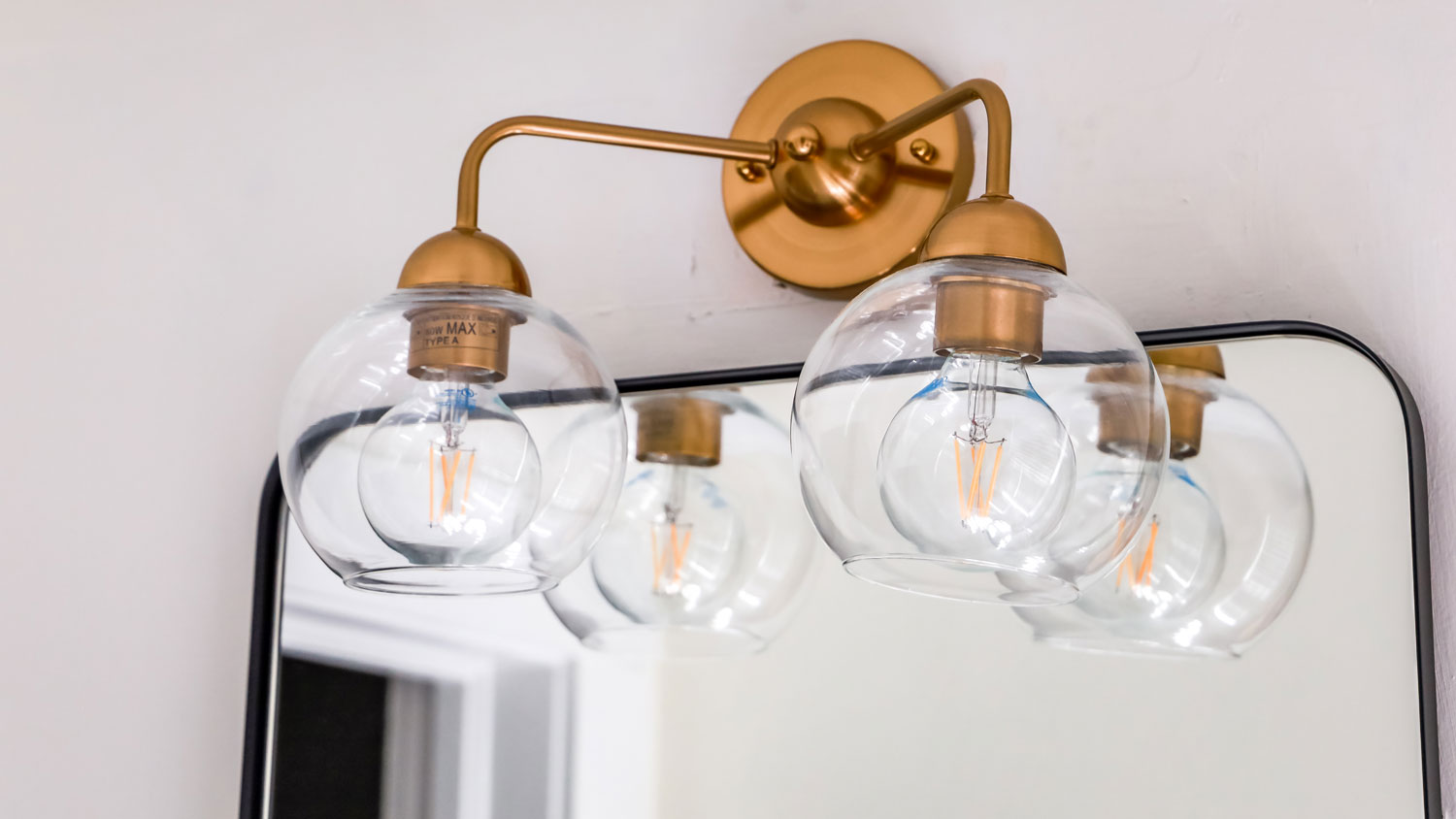 glass double light fixture in bathroom