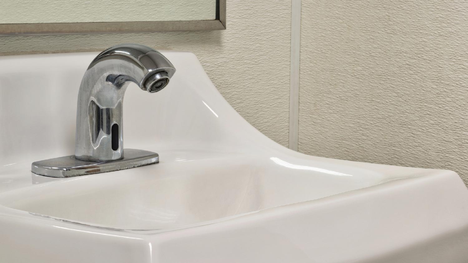 A bathroom sink with a touchless faucet