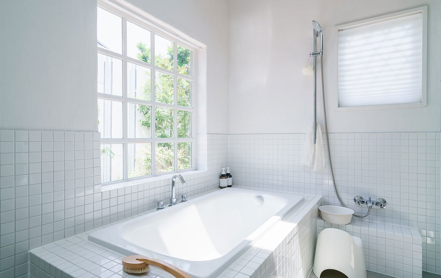 bright white tile bathroom with big window