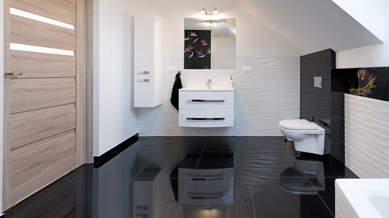 Black tile flooring installed in a modern bathroom