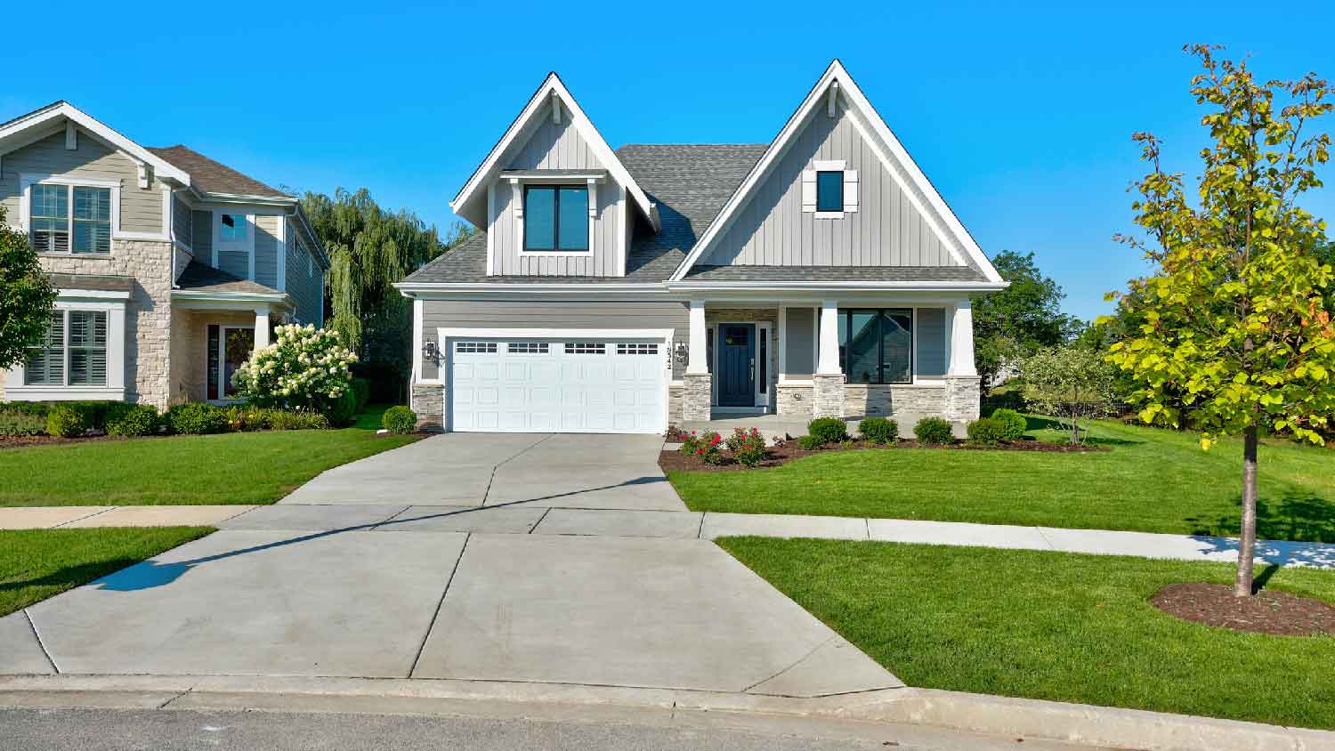 A beautiful house with concrete driveway