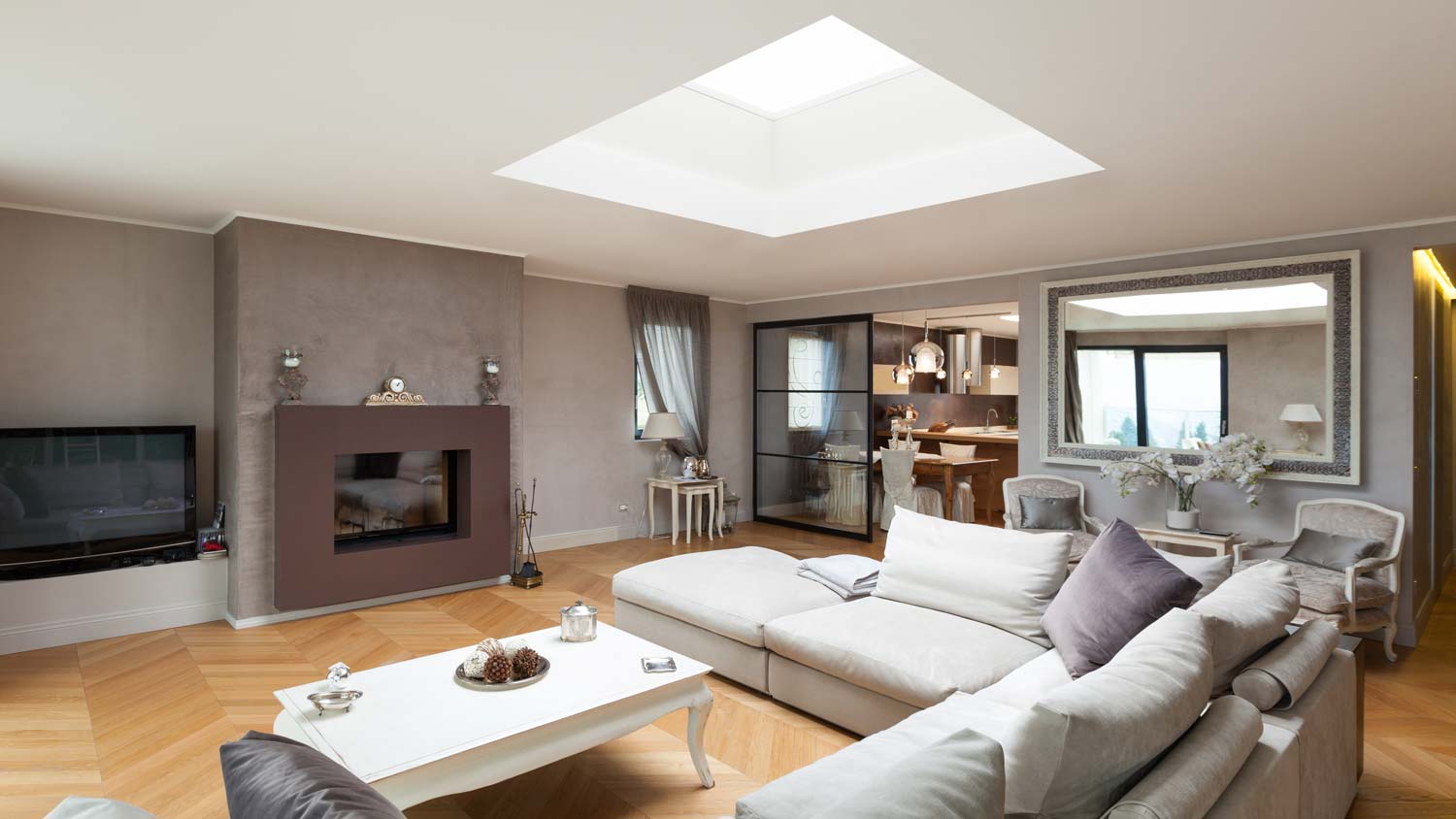 A beautiful living room with a skylight above the sofa