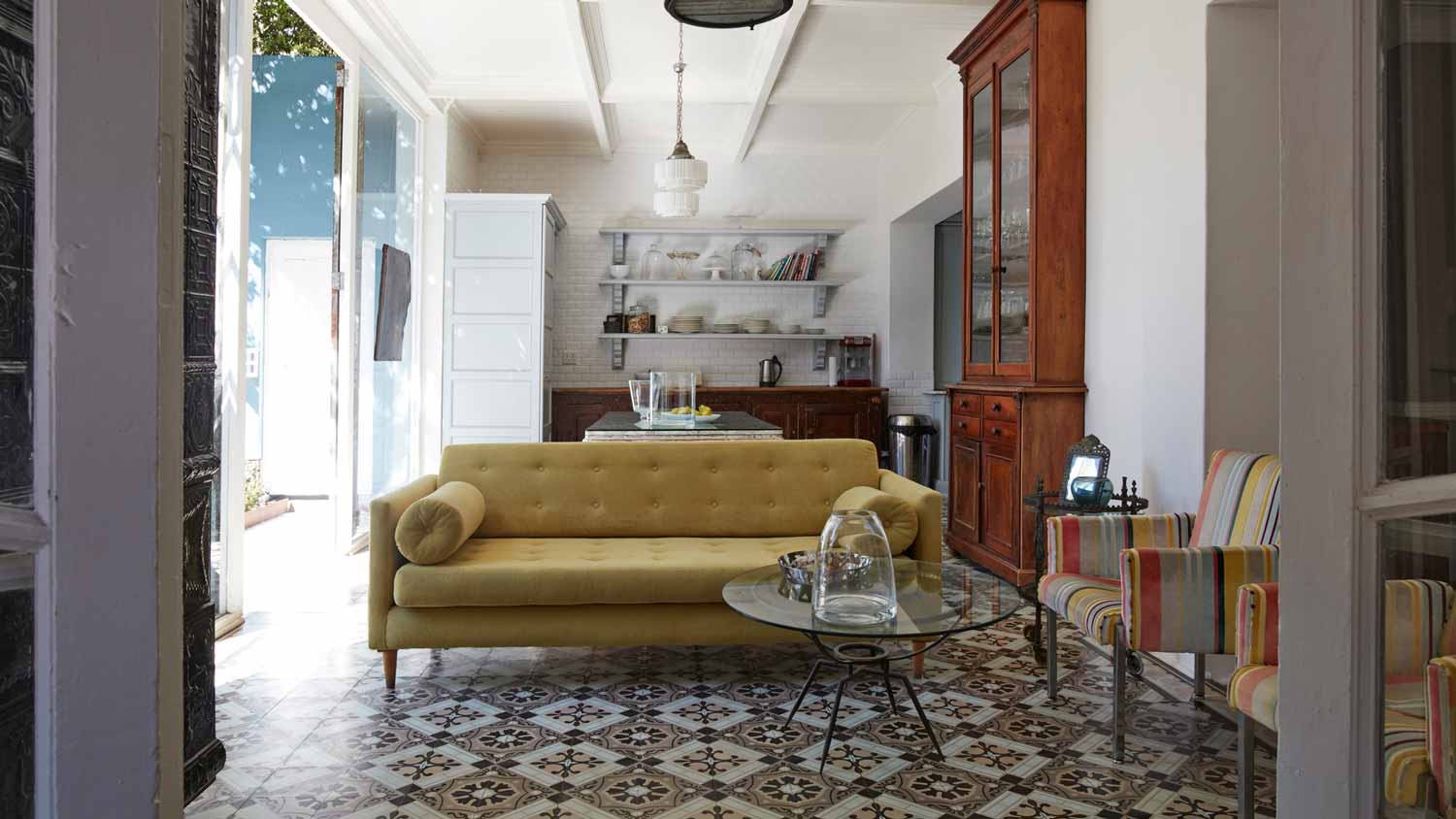 A beautiful open kitchen/living-room with cement tiles for flooring