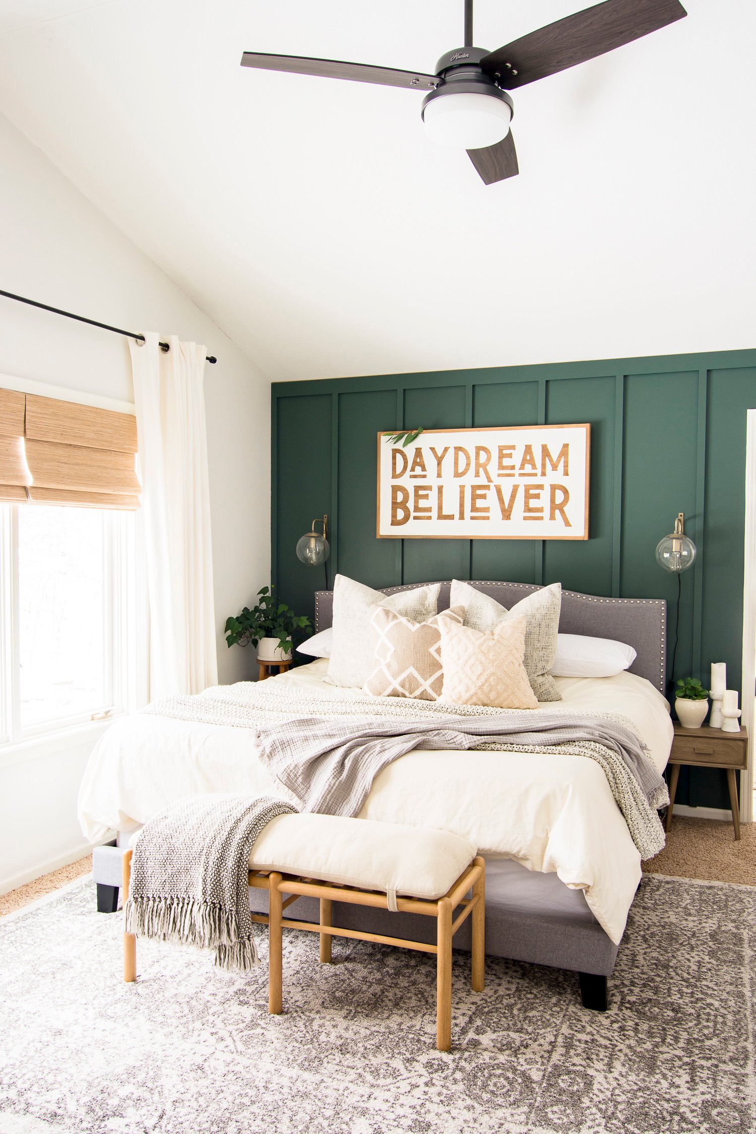  bedroom with dark green accent wall  