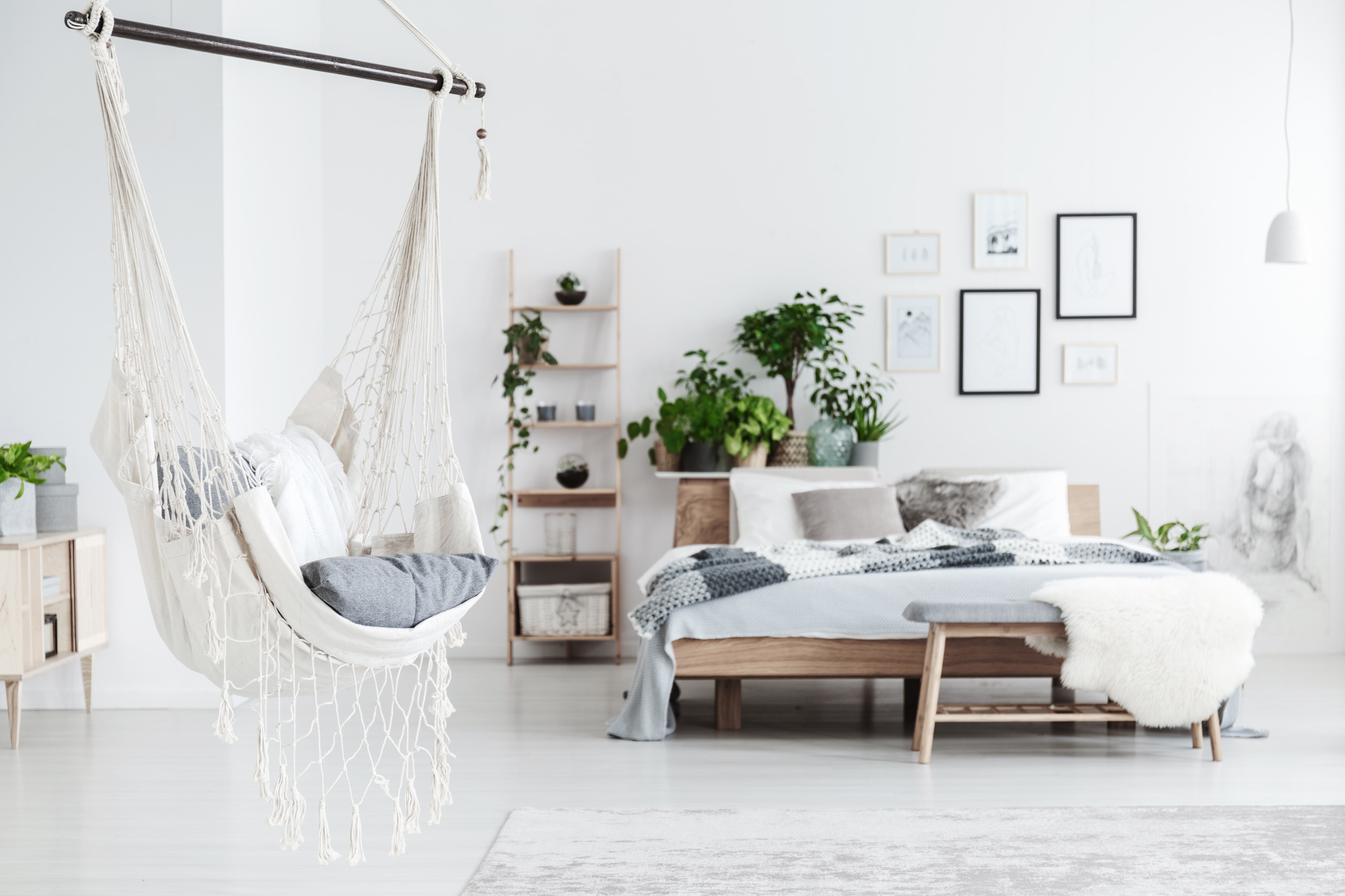 White hanging swing in a bright, modern bedroom