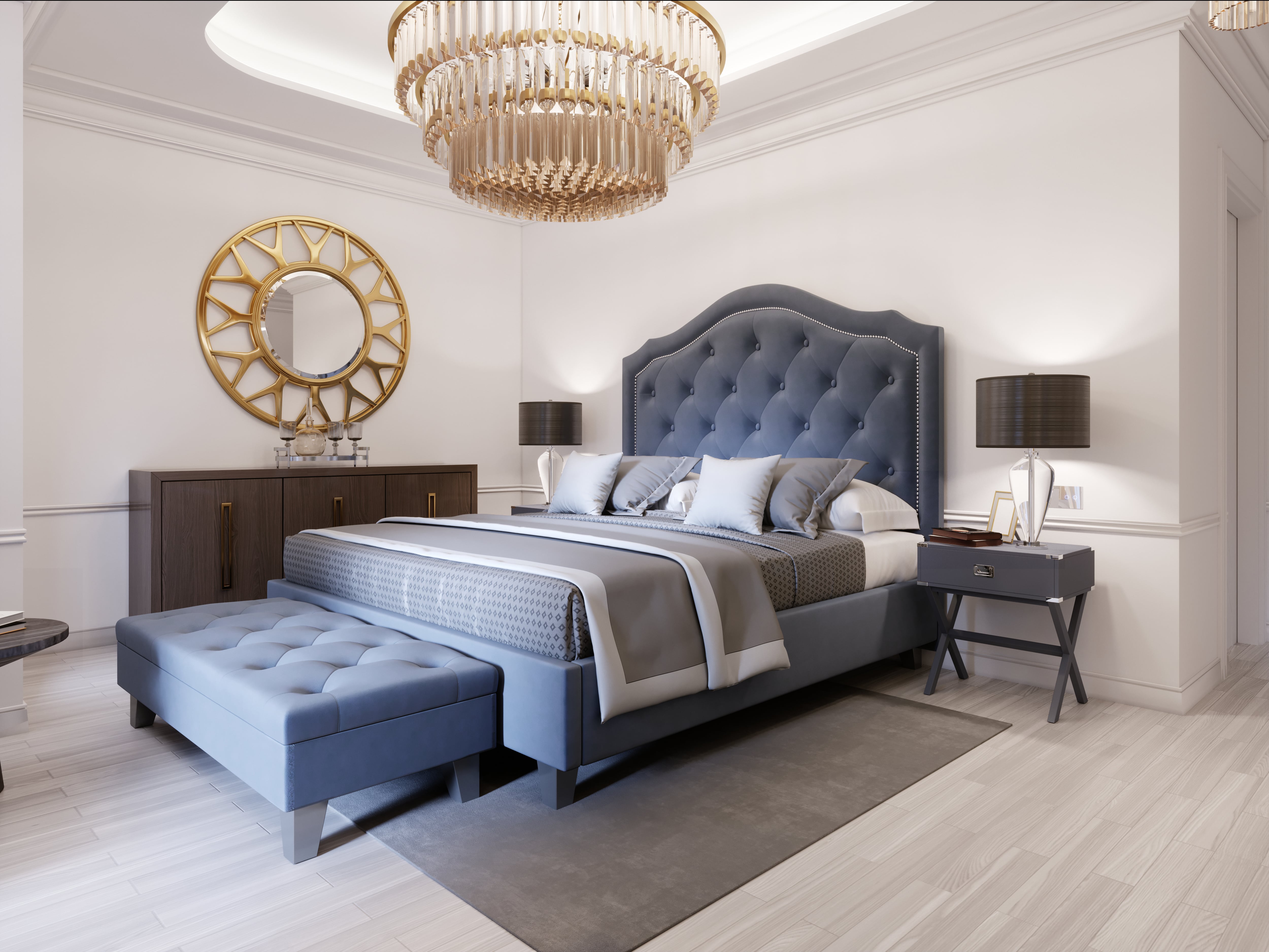 Elegant bedroom with blue bed, decorative mirror, and chandelier