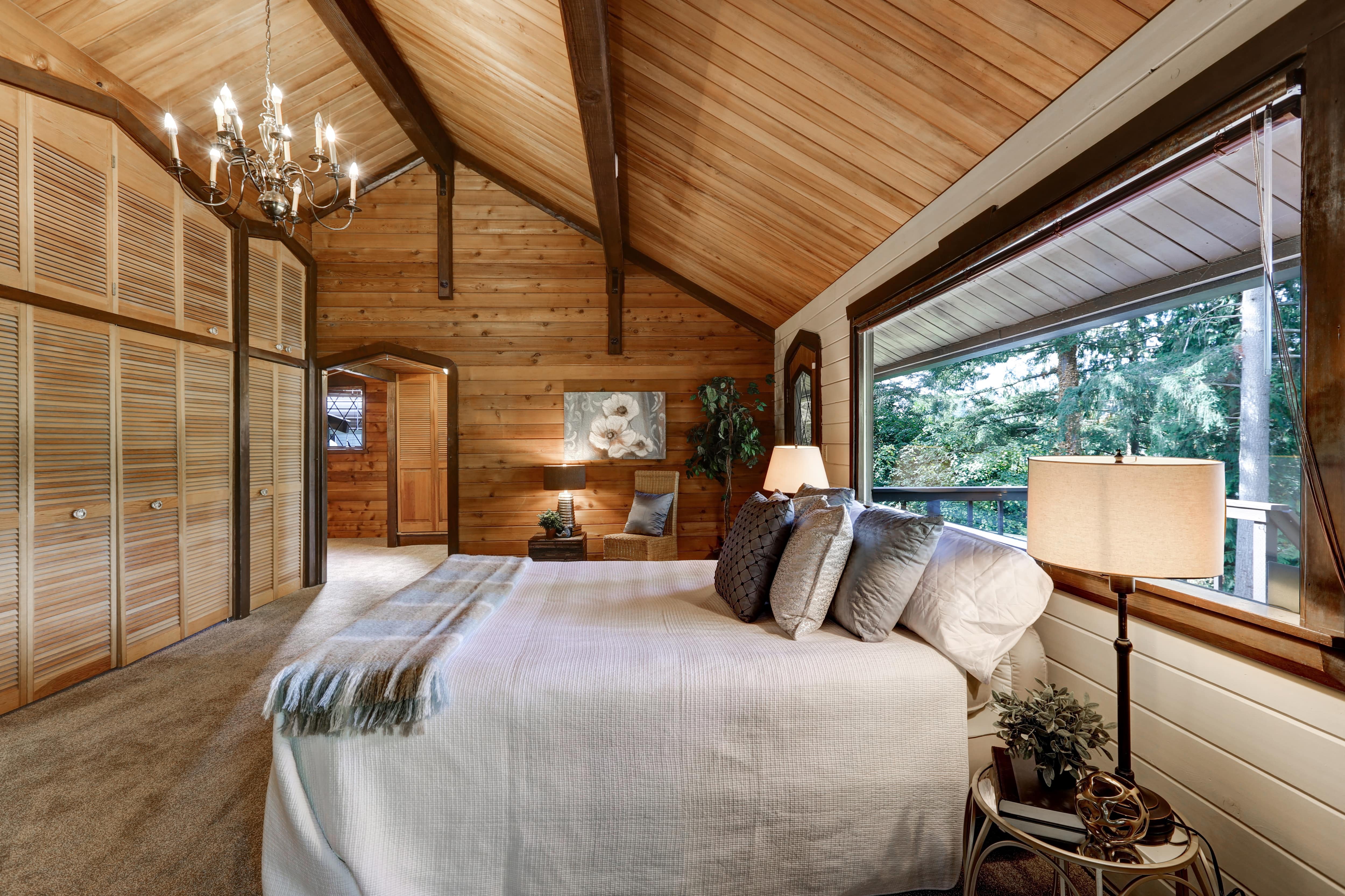 Modern bedroom with wood paneled walls and ceilings