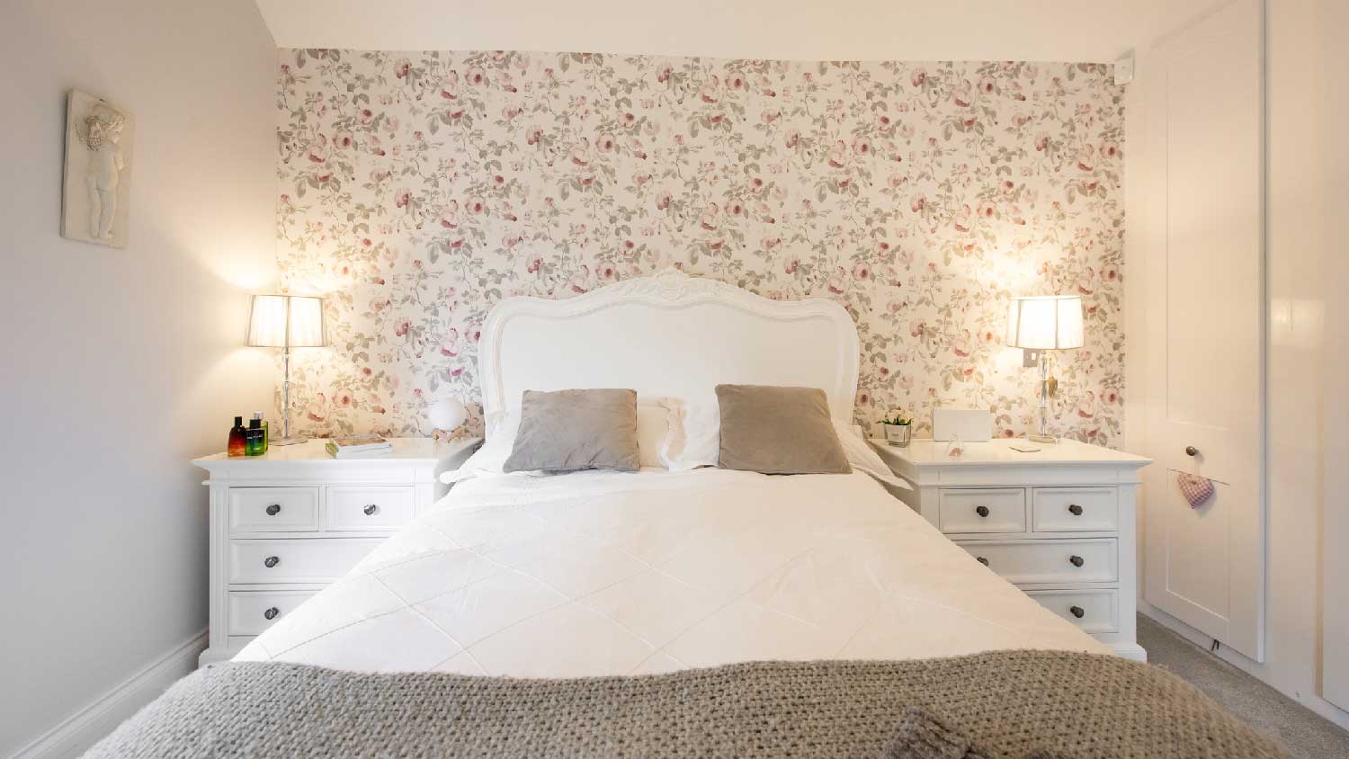 A bedroom with floral wallpaper
