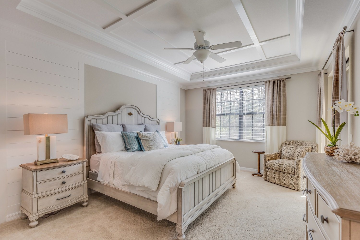 Bedroom with light grey walls and white accent wall