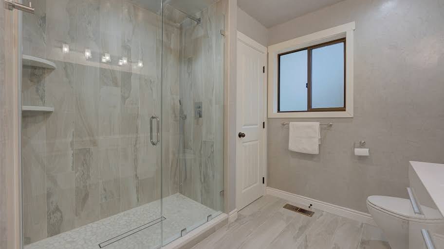 beige stone bathroom with shower storage 