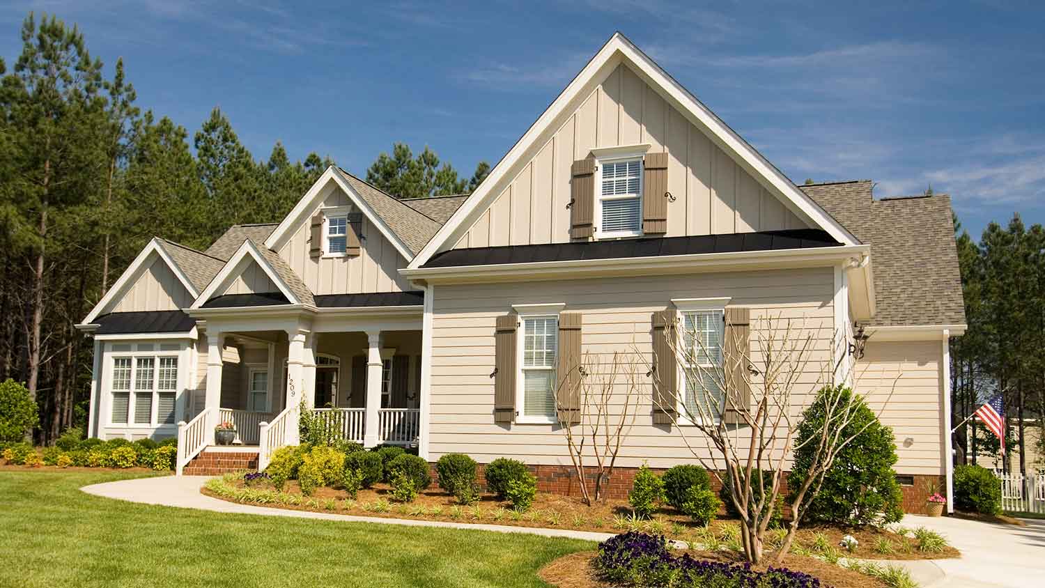 Beige siding house with window shutters