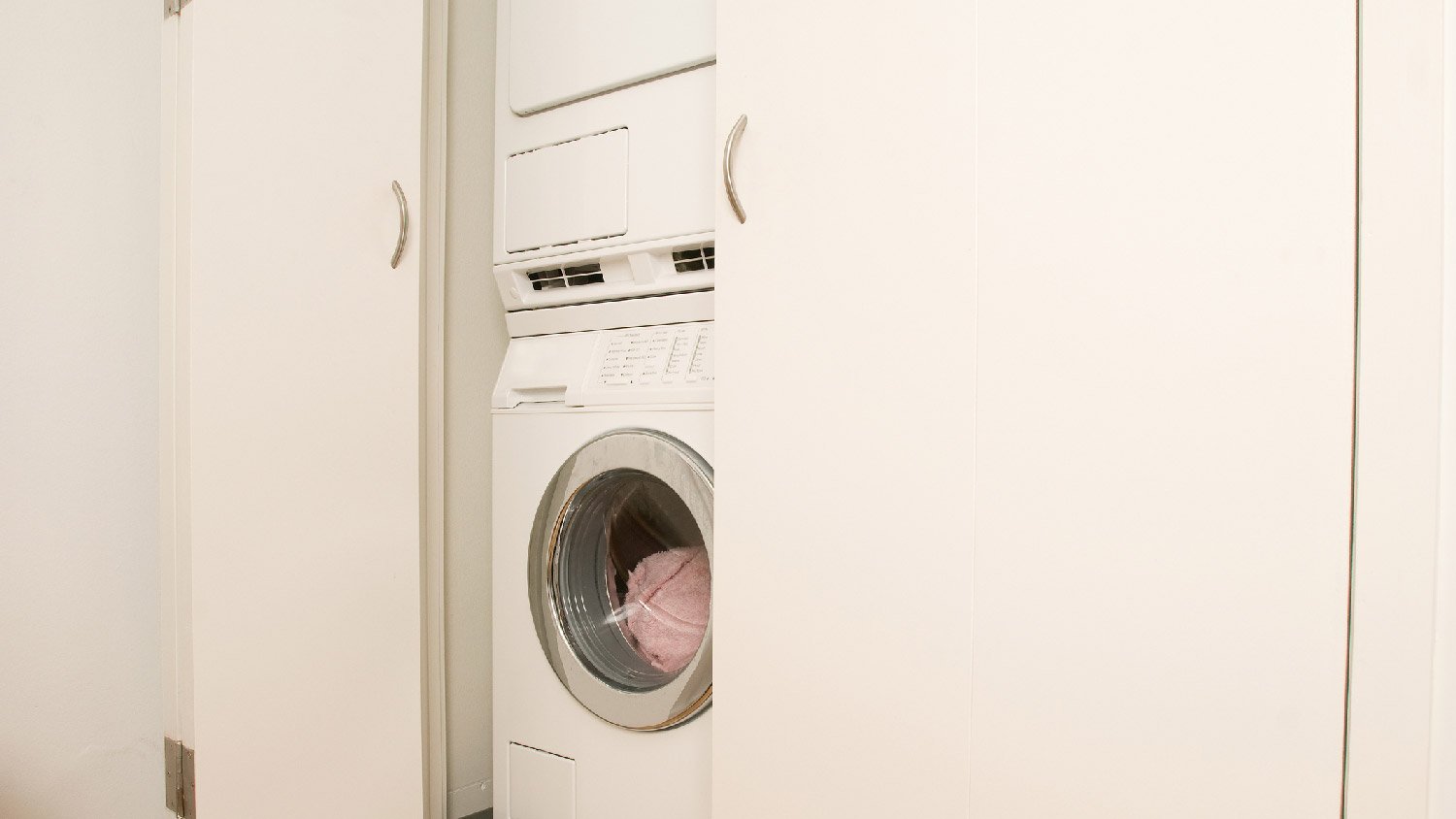 Washer and dryer behind bi-fold doors