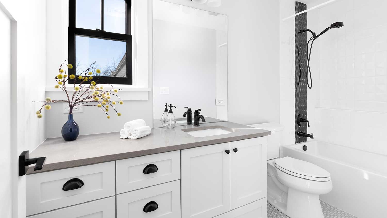 Modern bathroom with white cabinets and gray countertop