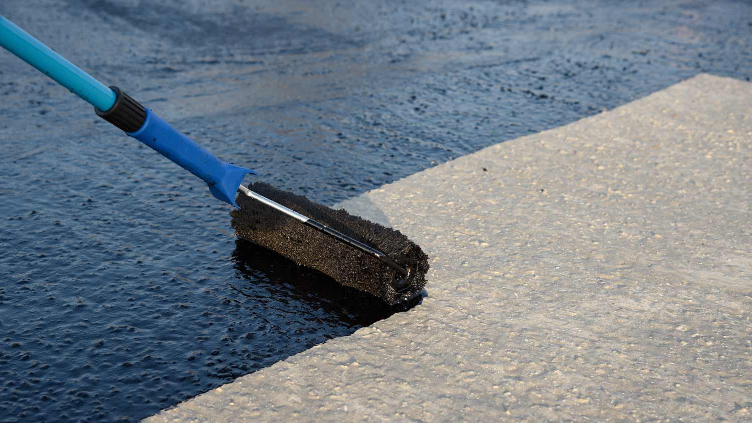 applying black paint to concrete