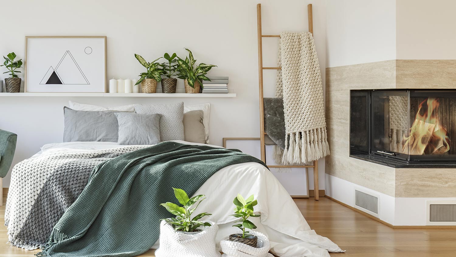 Blankets on ladder by fireplace in cozy bedroom