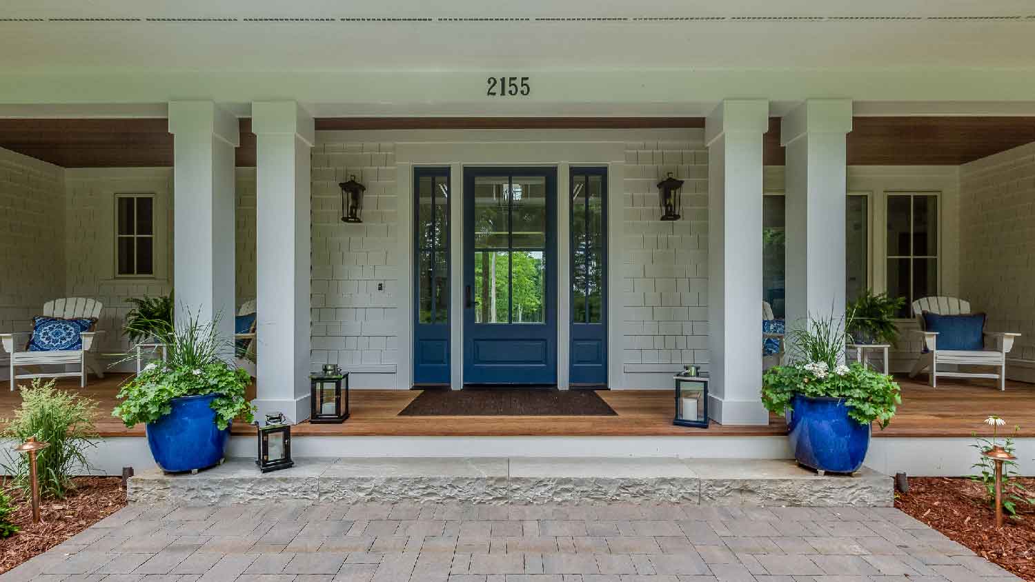 A large porch with a blue front door