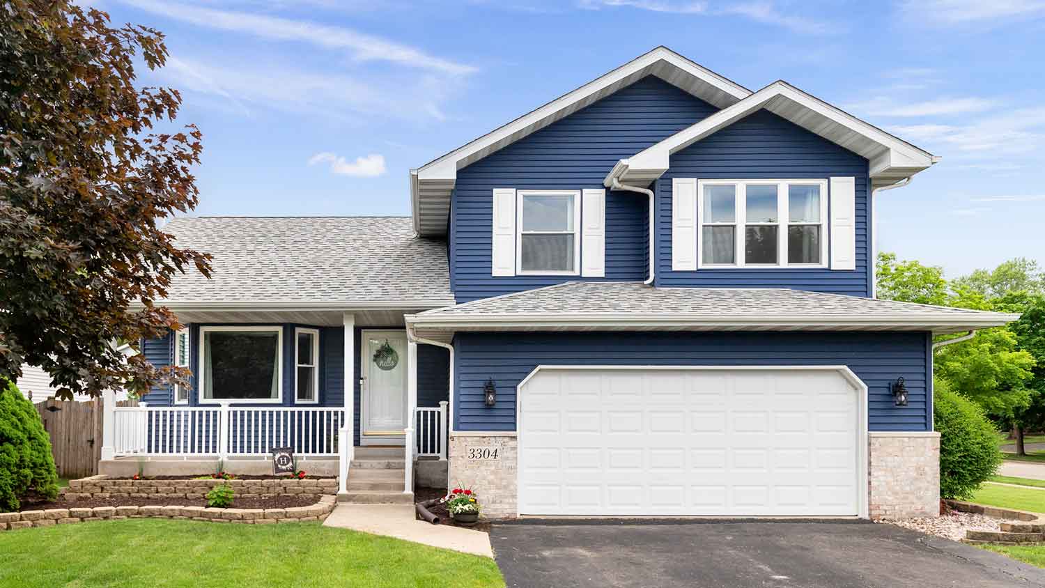 Exterior of a blue house with white window shutter