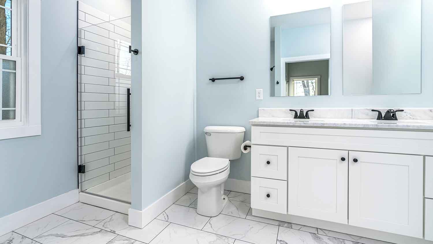 Standard size primary bathroom with blue walls 