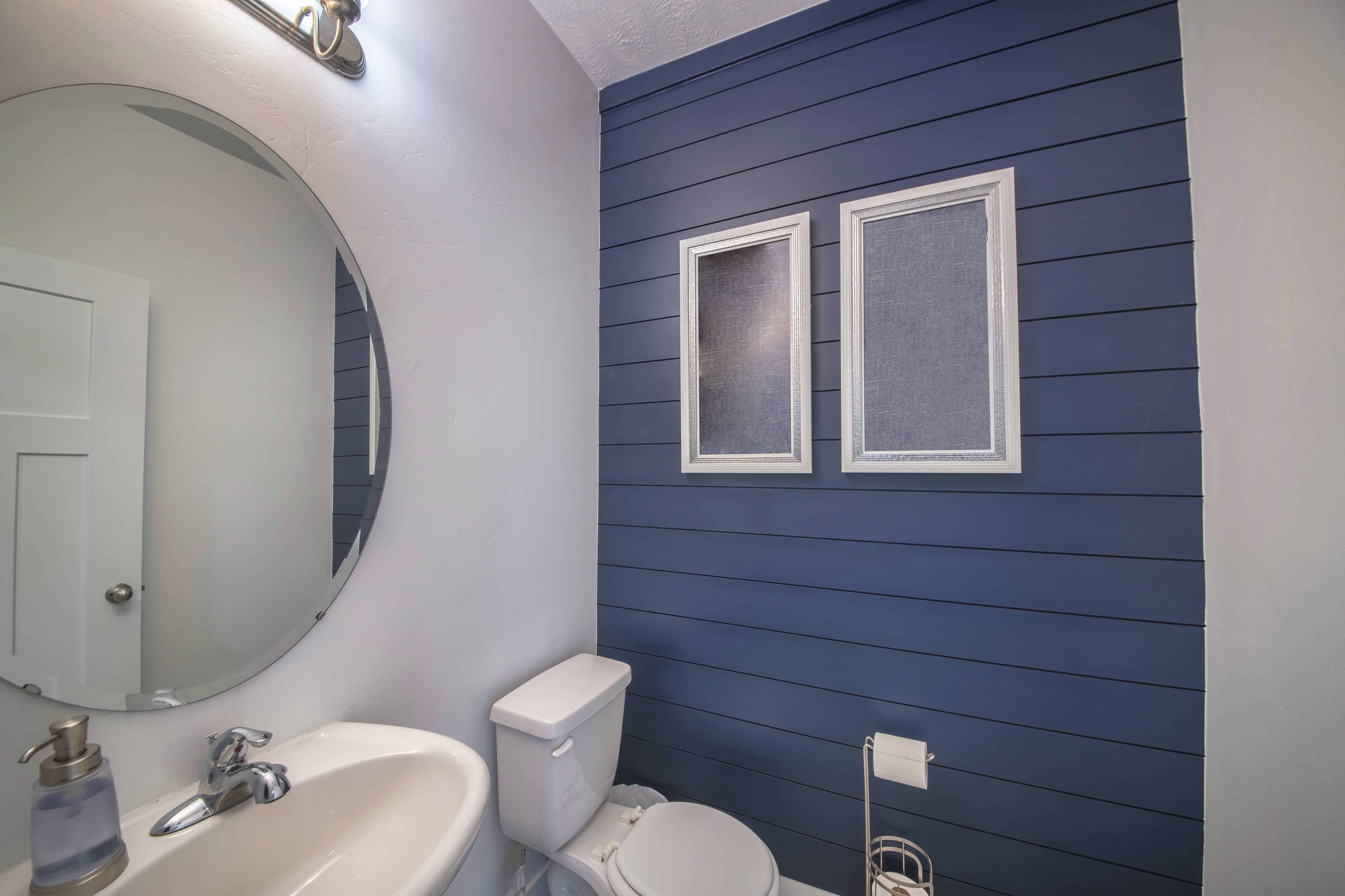 Powder room with navy blue shiplap accent wall