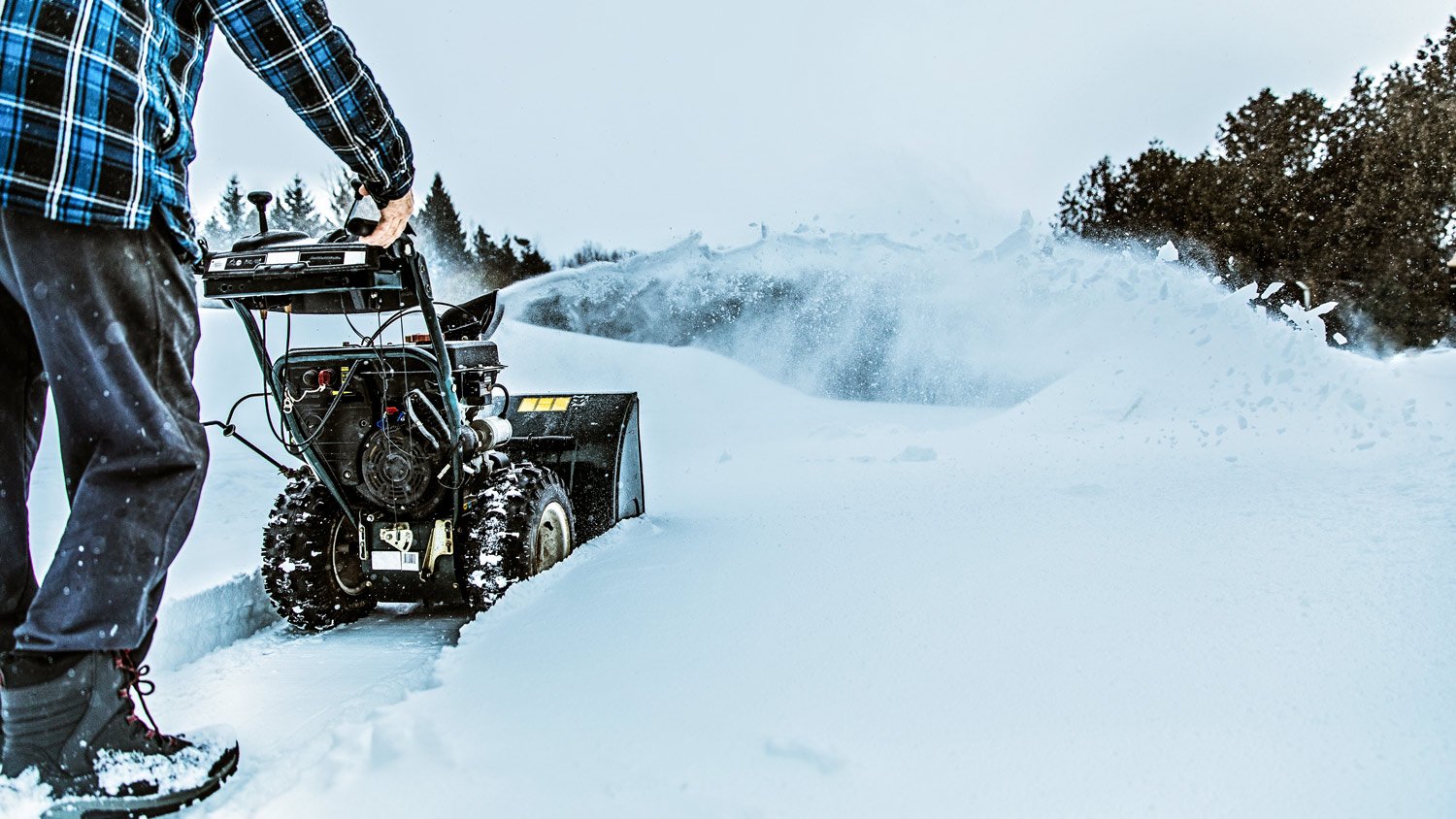 Man Using a Snowblower Outdoors