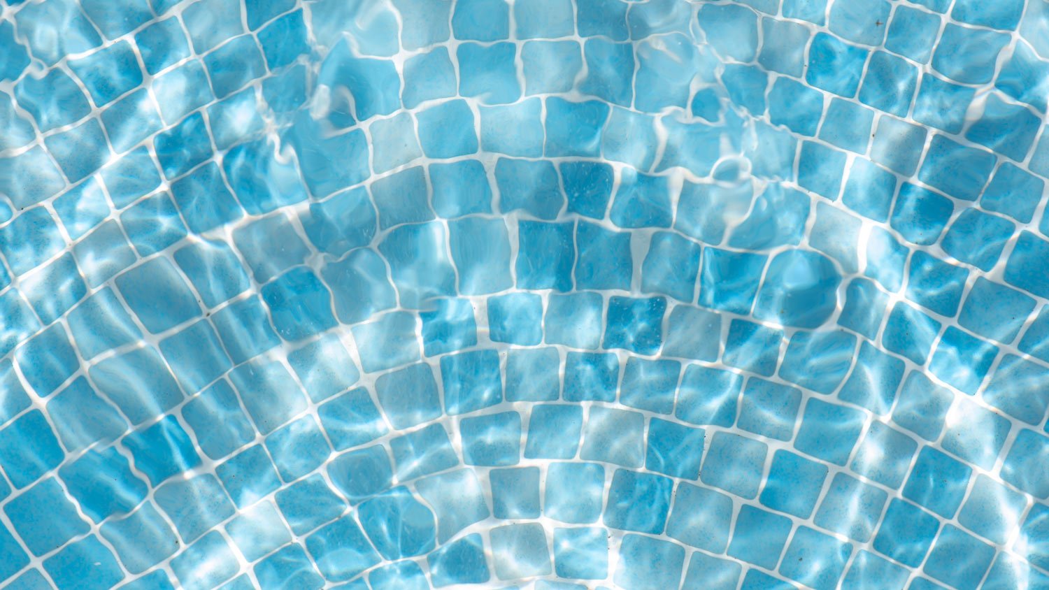 Bluish mosiac in a swimming pool with water moving