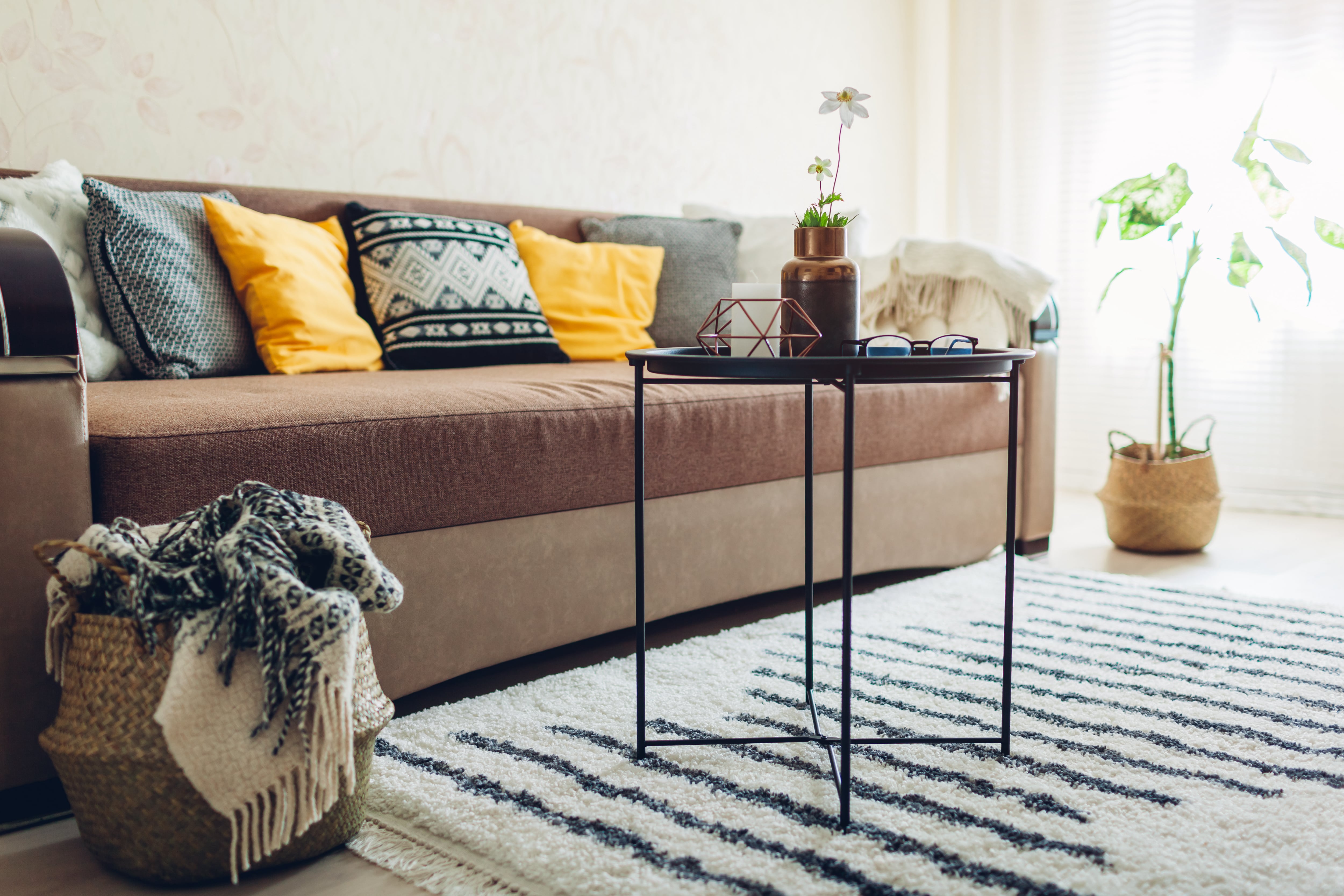 Couch in living room with throw pillows and small coffee table
