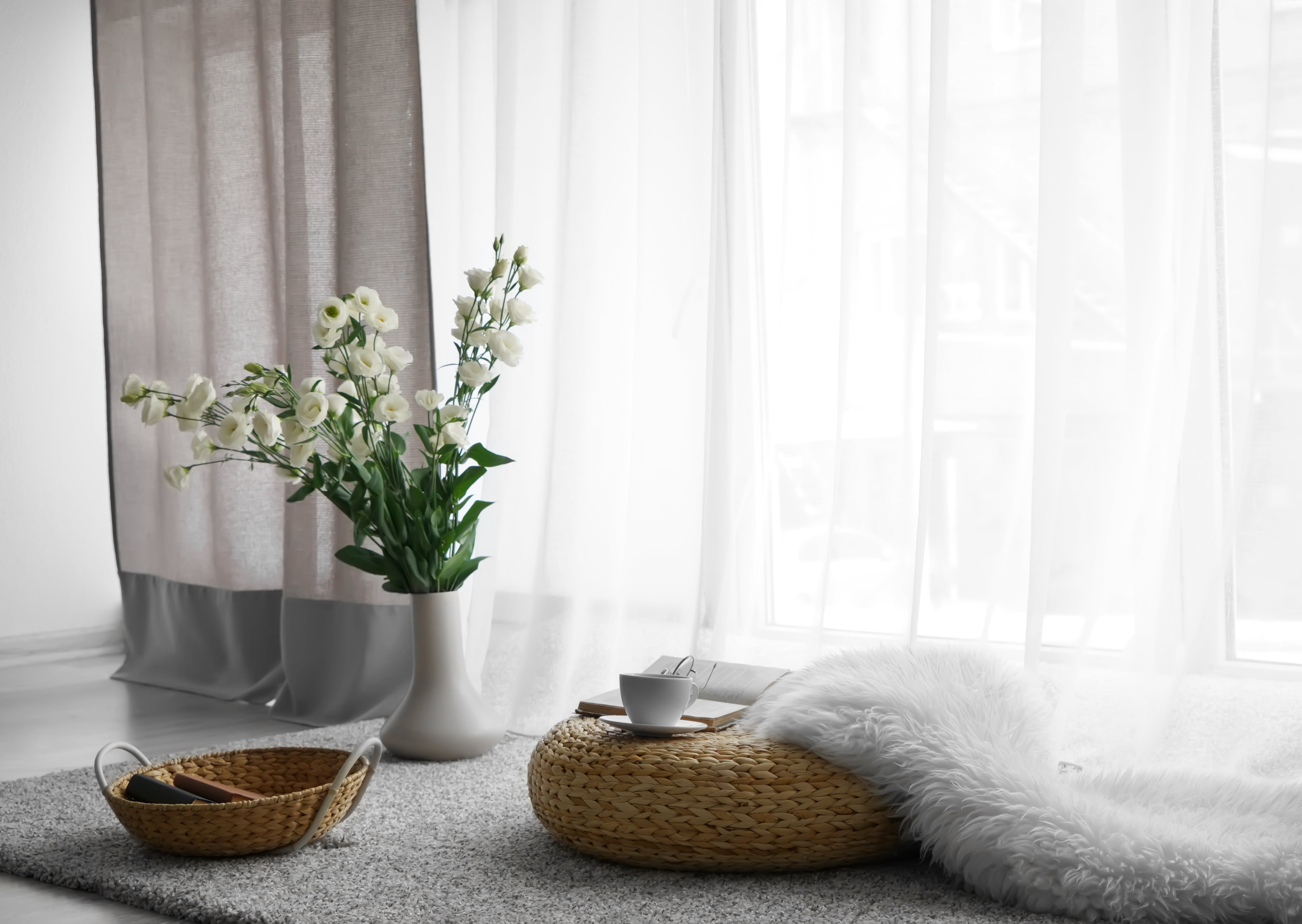 Straw floor pillow in front of window