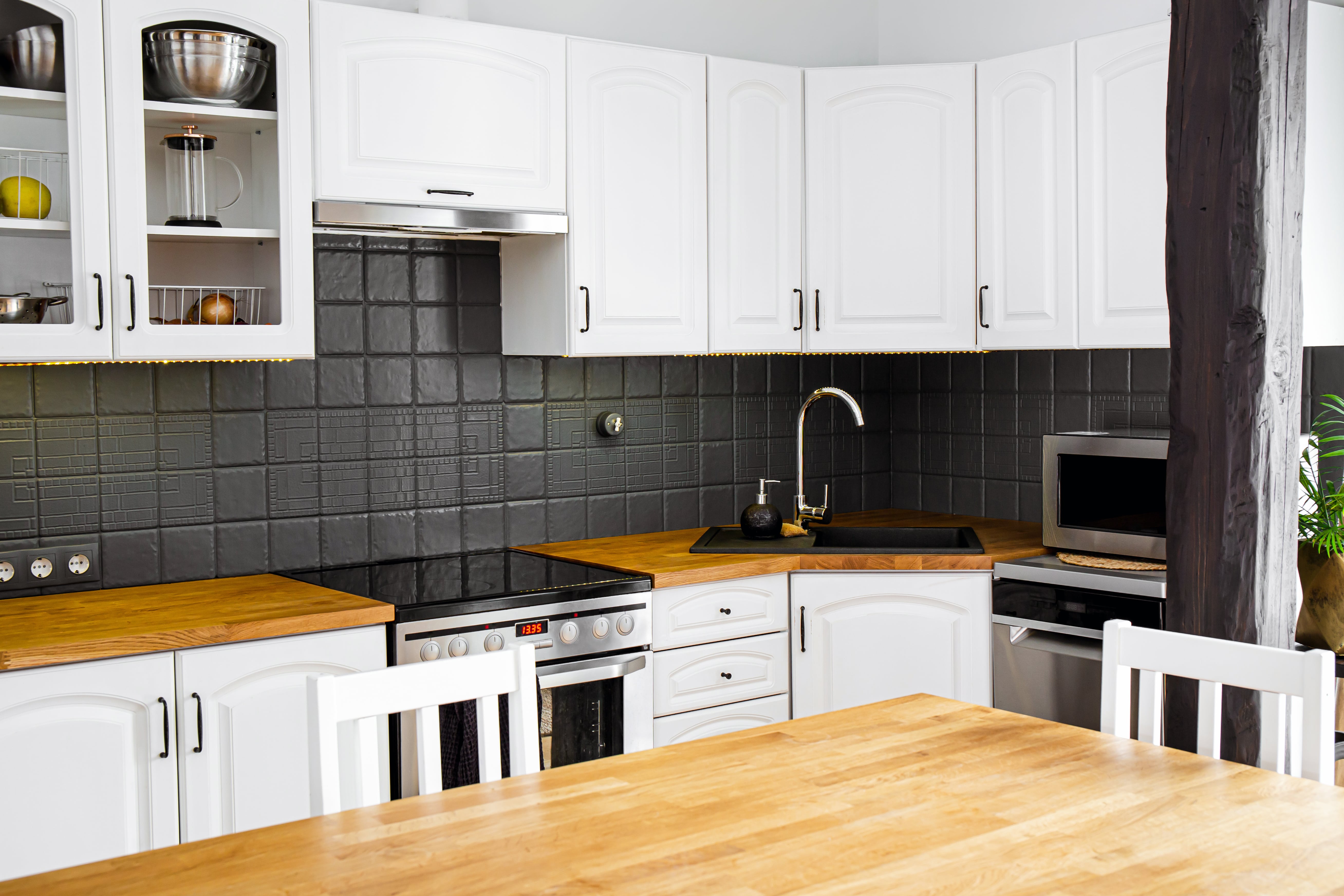 Black-and-white kitchen with wood countertops