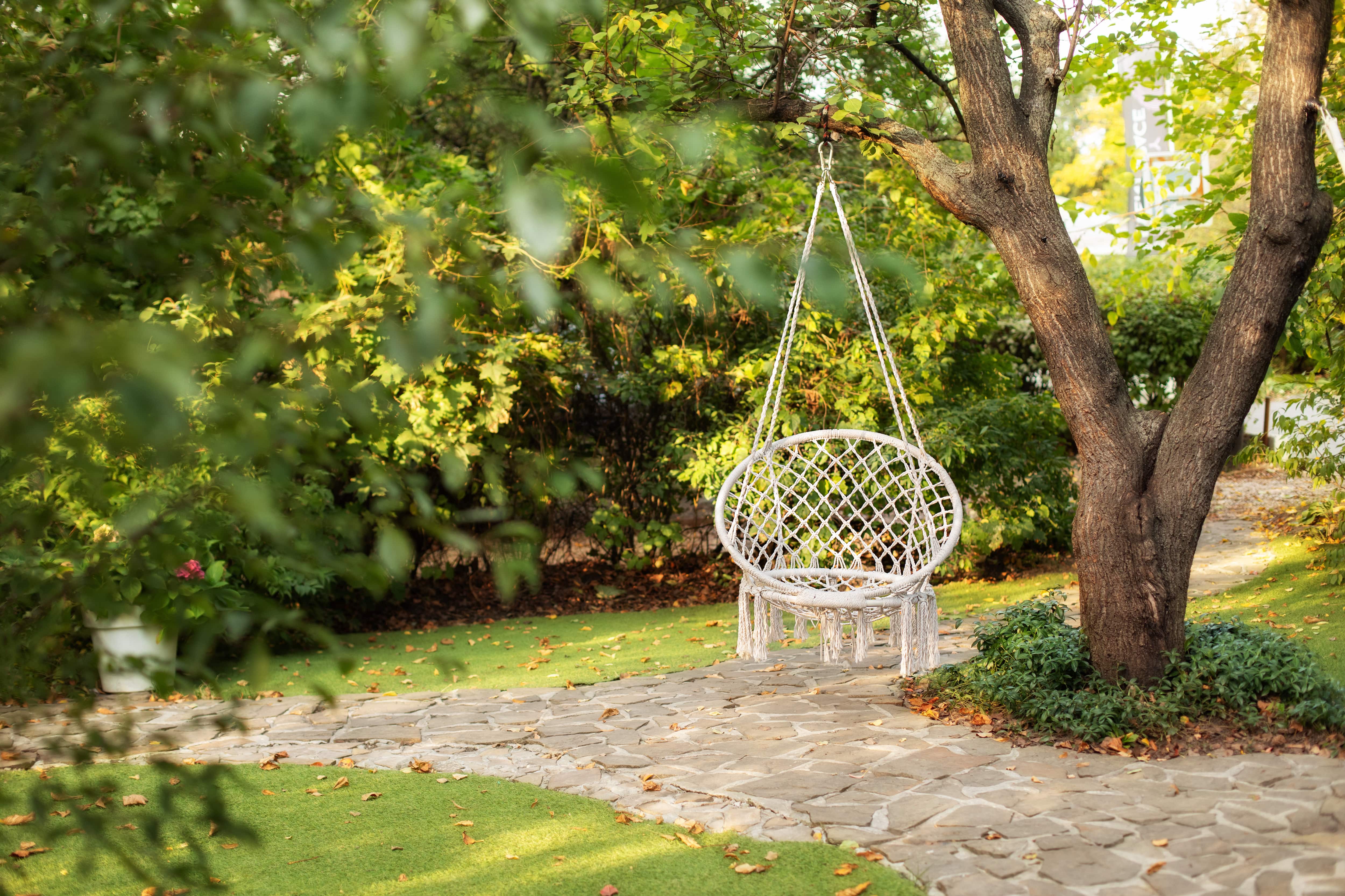 Hanging macrame swing in backyard