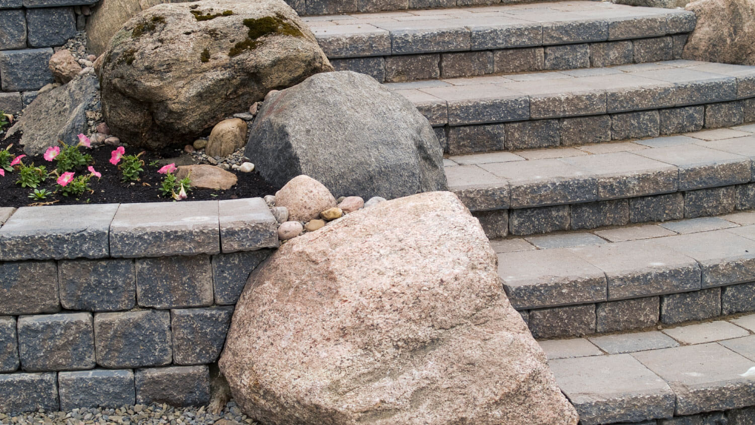 boulders on the side of concrete paver steps landscaping