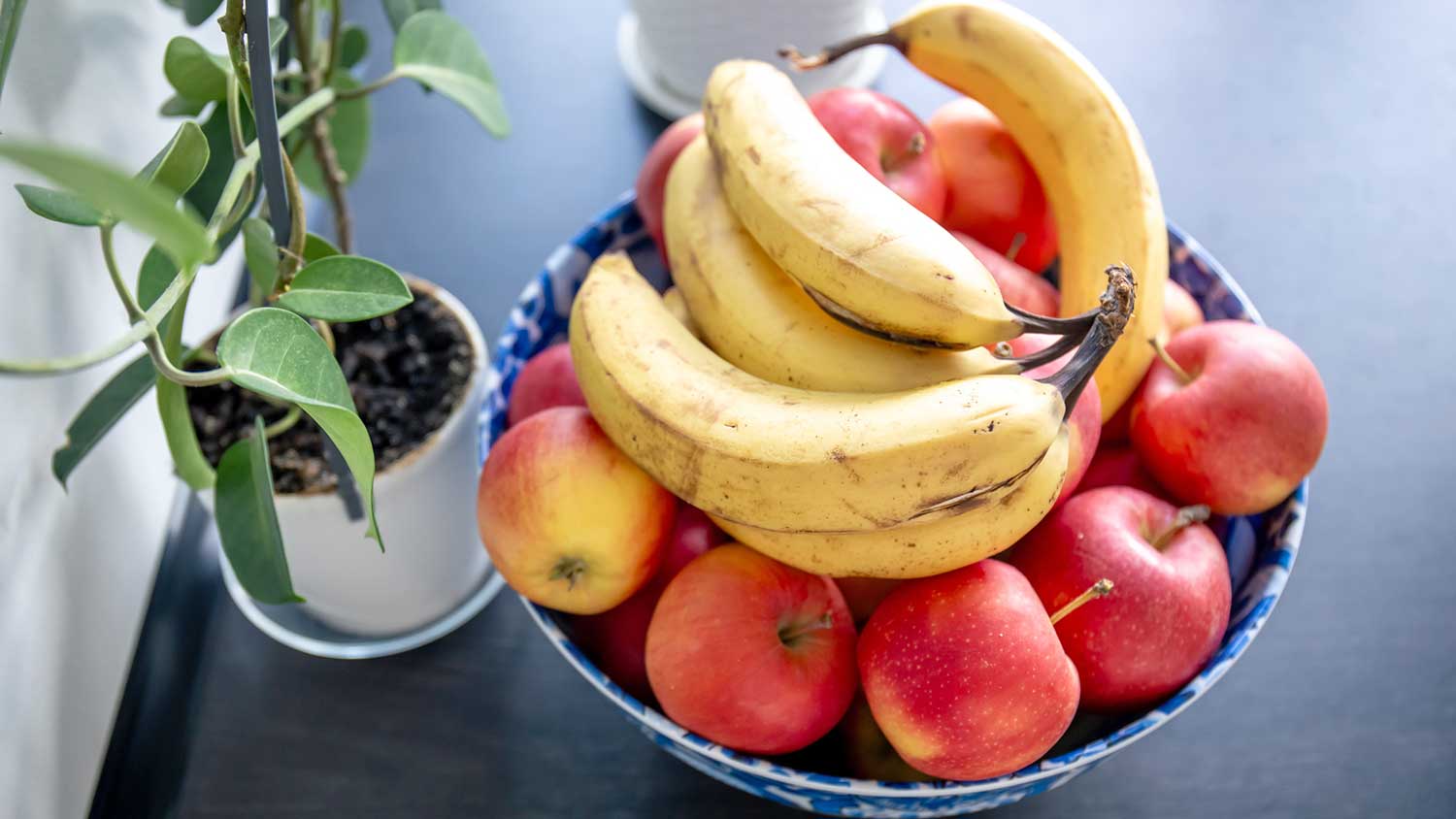 Fruit bowl with apples and ripe bananas